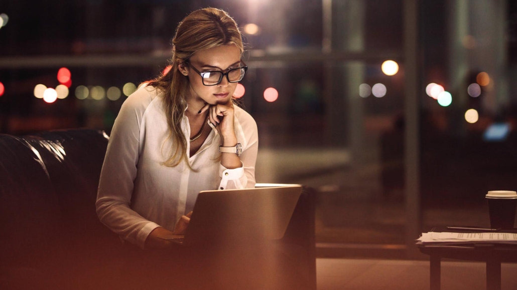 Business woman working late on laptop